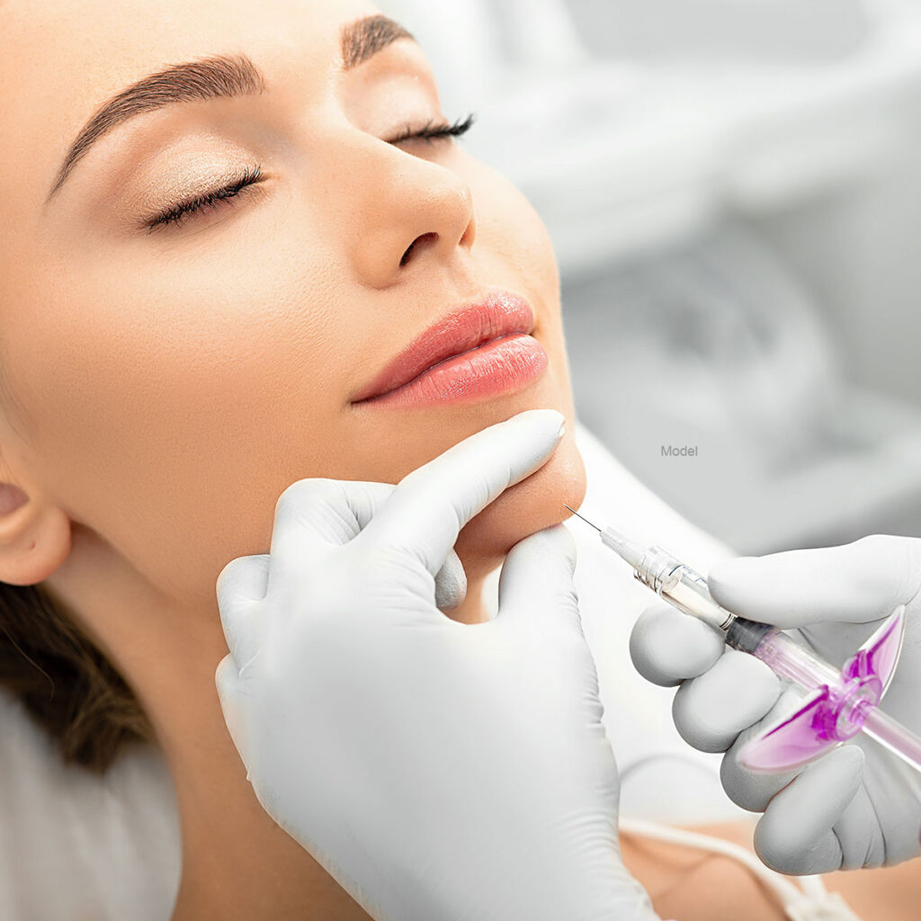 Woman during skin tightening procedure, injection of dermal filler into a female face.